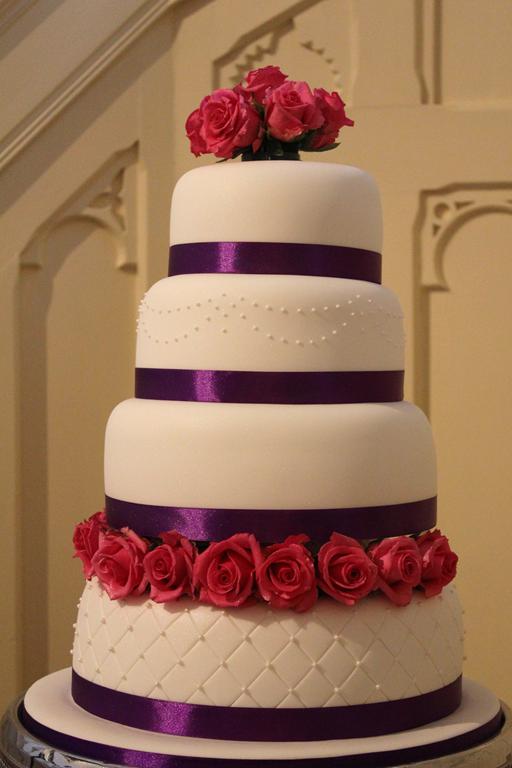 Fuchsia pink roses and purple wedding cake
