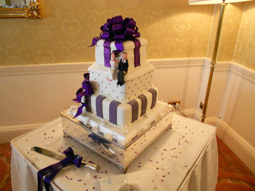 Purple bow and stripes wedding cake