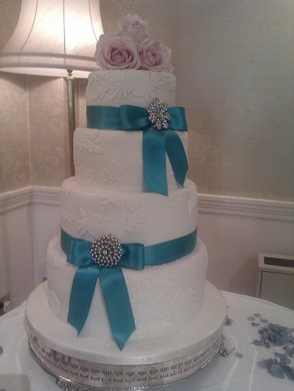 Turquoise and lace wedding cake