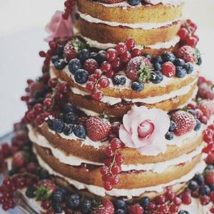 Naked berry and roses wedding cake