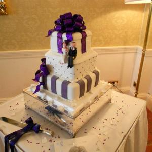 Purple bow and stripes wedding cake